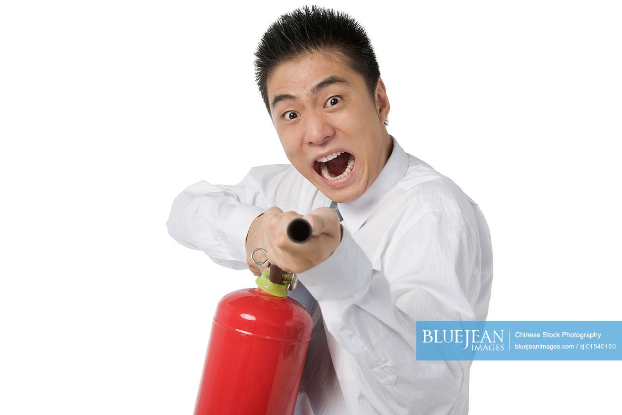 Chinese businessman with fire extinguisher