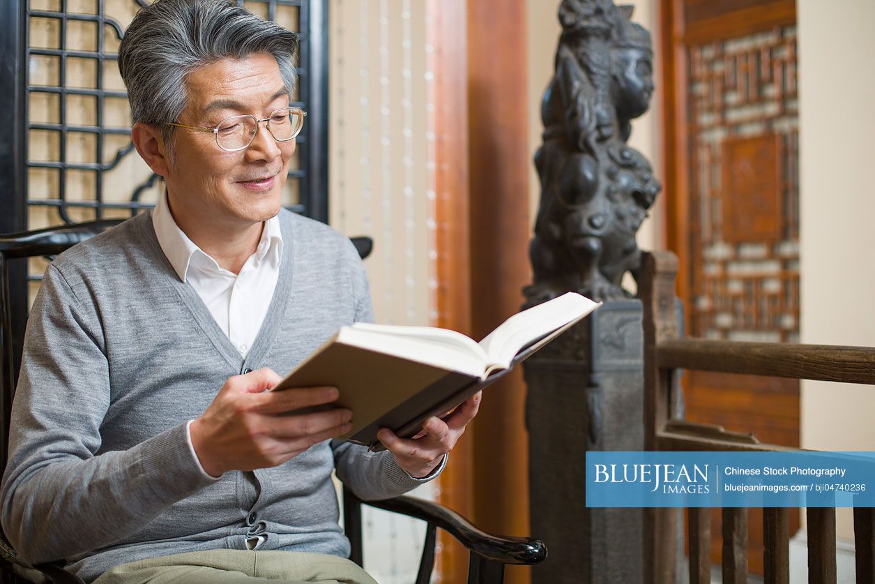 Senior Chinese man reading book