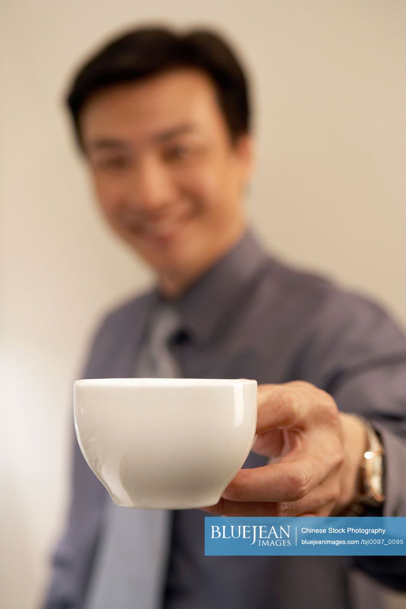 Chinese Young Man Holding Coffee Cup