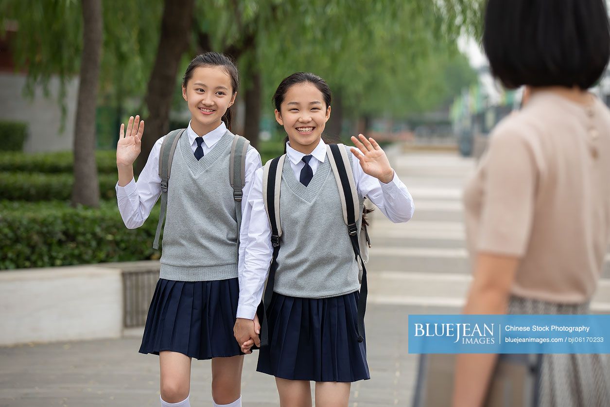 Chinese students waving to teacher