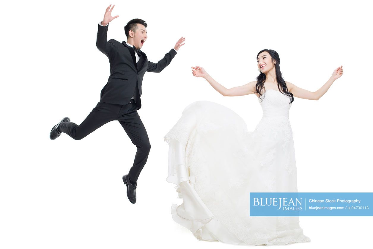 Happy Chinese bride and groom flying