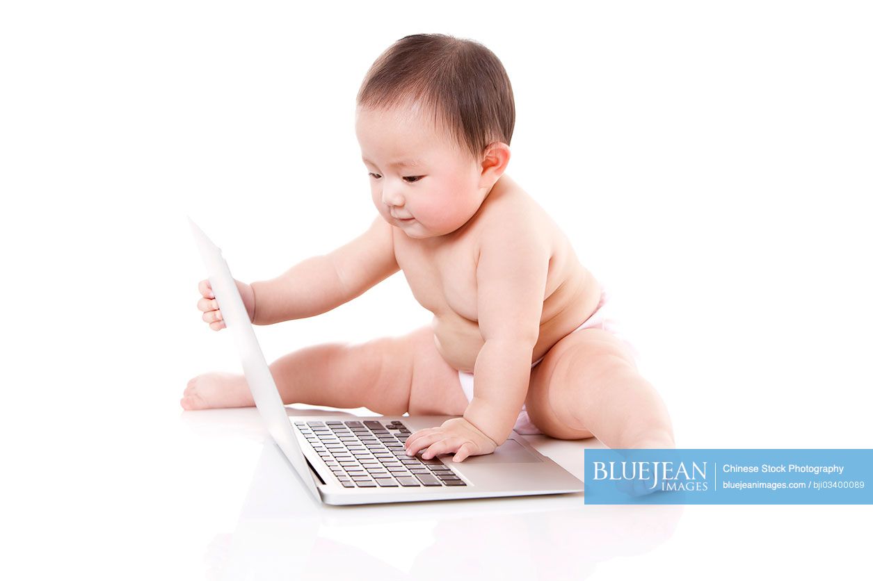 Cute Chinese baby girl with laptop