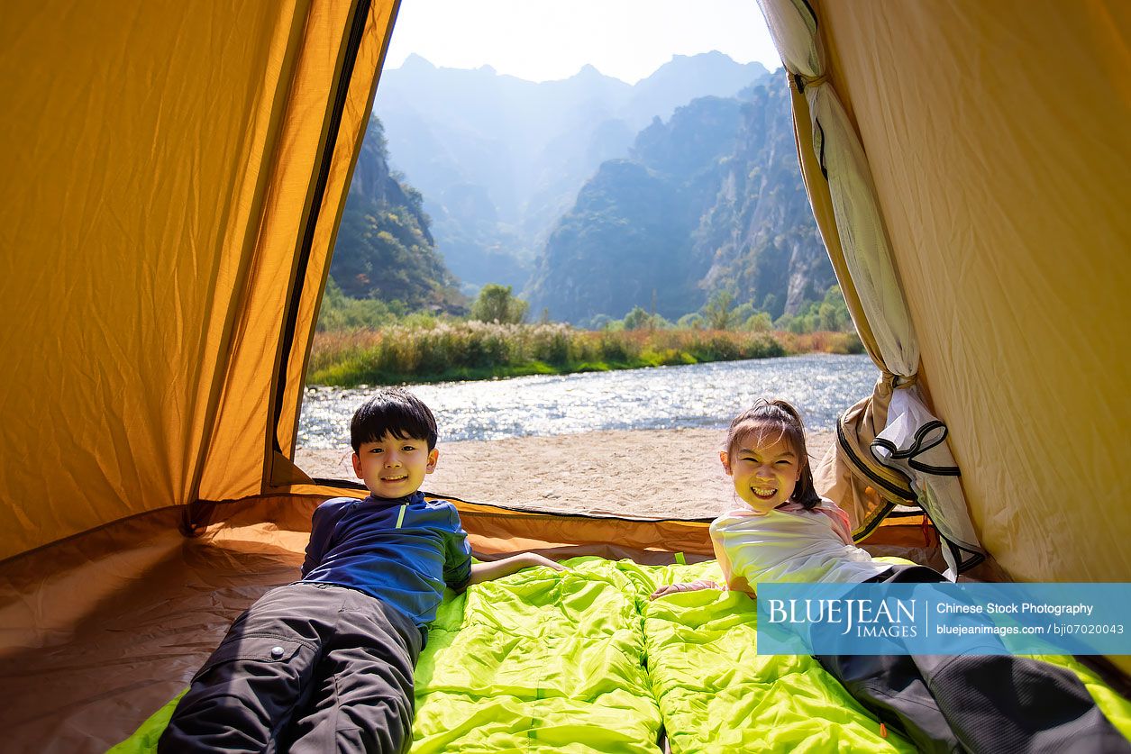 Cute Chinese Children relaxing in tent