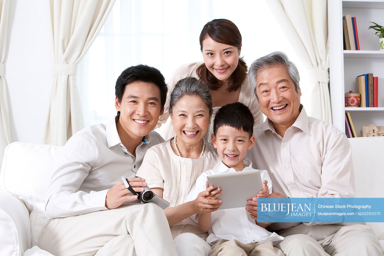 Happy Chinese family using an ipad together