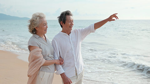 Happy senior Chinese couple on beach,4K