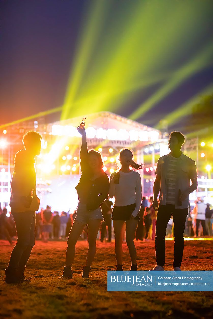Happy young Chinese friends at music festival