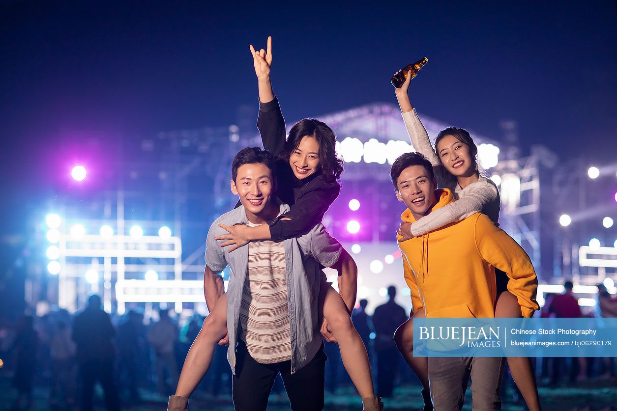 Happy young Chinese friends at music festival