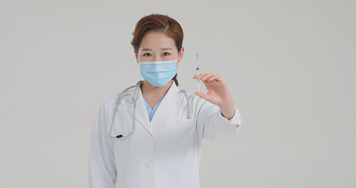 Young Chinese doctor holding syringe,4K