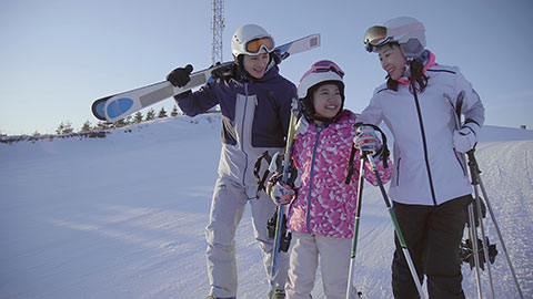 Happy young Chinese family relaxing in ski resort,4K