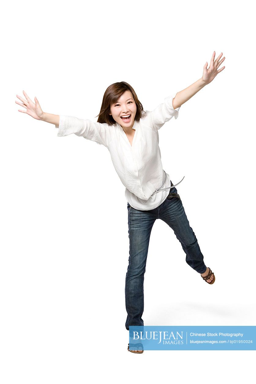 Portrait of young Chinese woman with arms outstretched