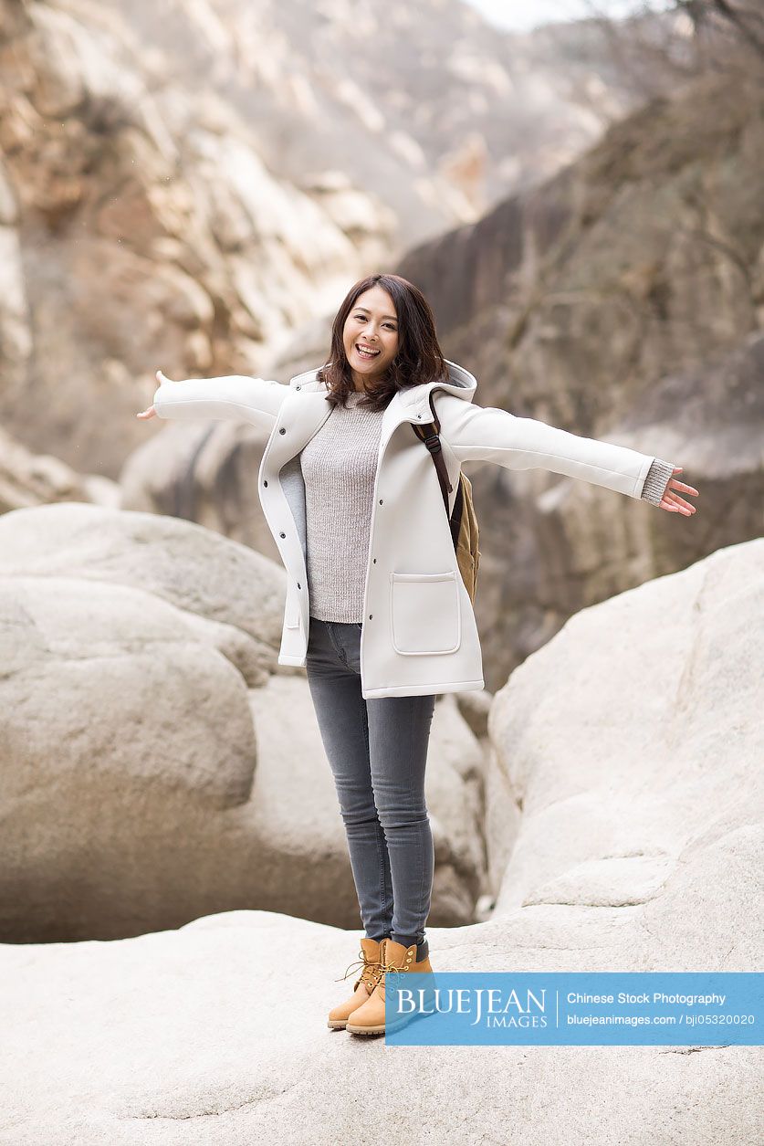 Portrait of cheerful young Chinese woman outdoors in winter-High-res ...