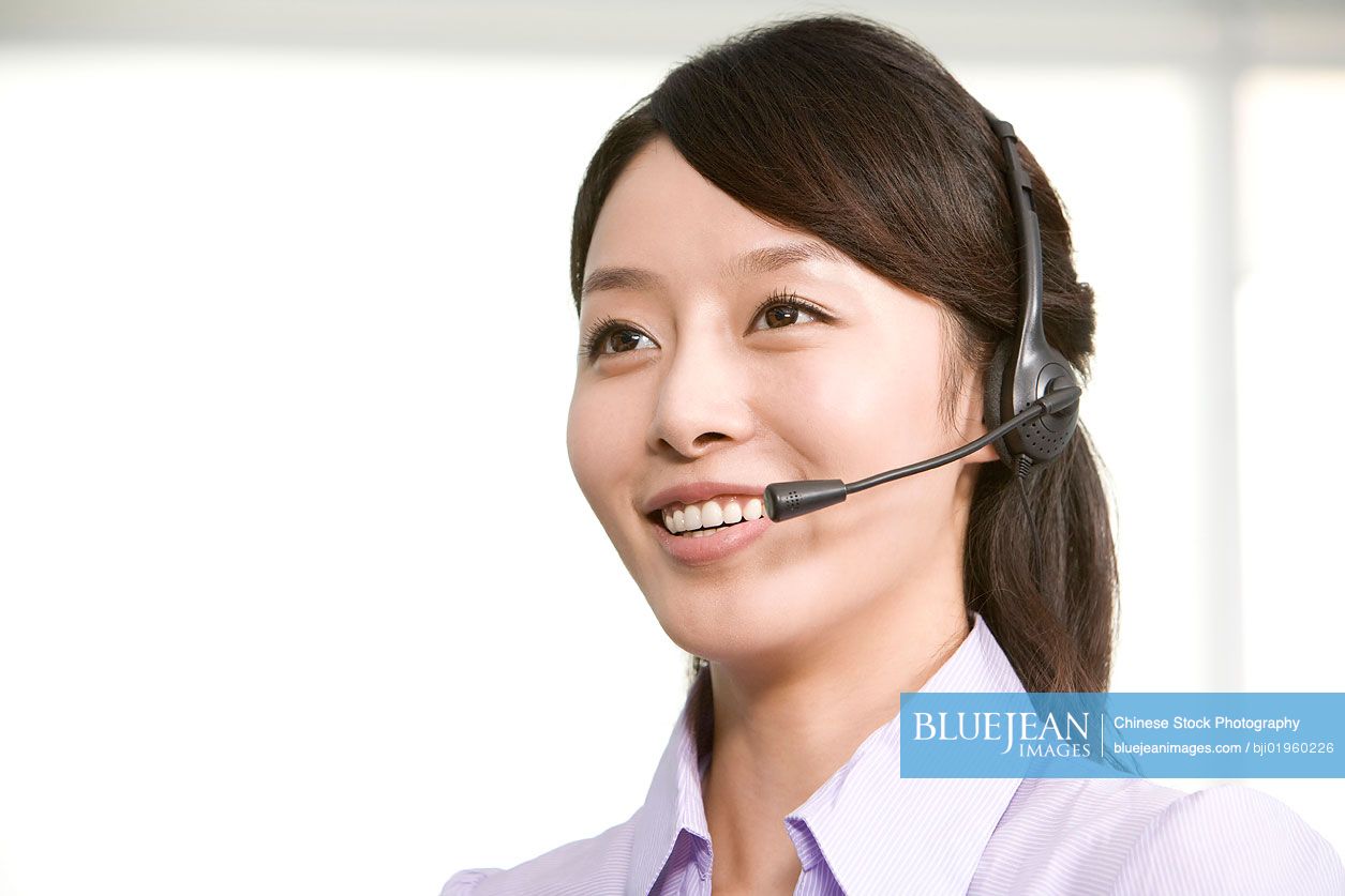 Chinese office worker with a headset