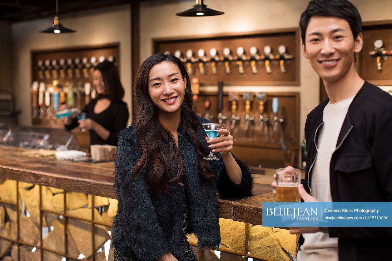 Happy Chinese friends having drinks and talking in bar-High-res stock ...
