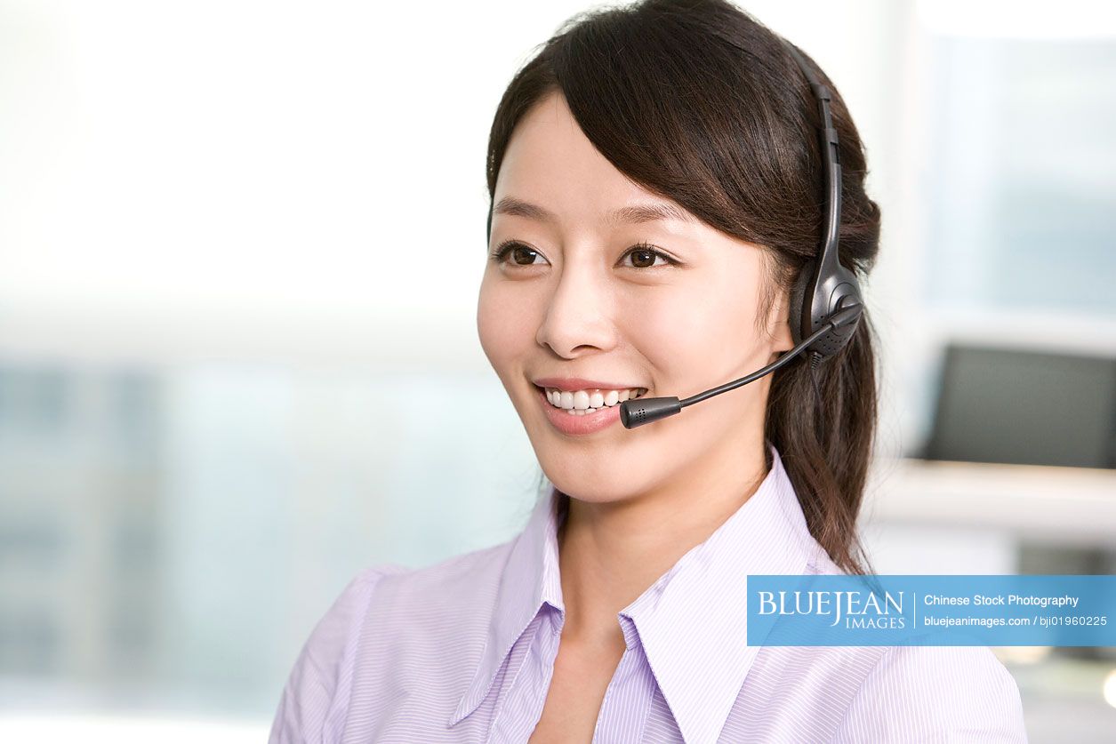 Chinese office worker with a headset