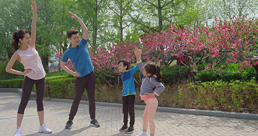 Happy young Chinese family exercising in park,4K