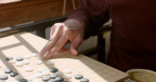 Senior Chinese man playing the game of go,4K