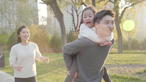 Happy young Chinese family having fun in park,4K