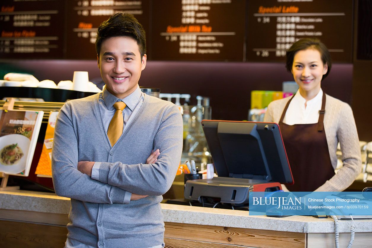 Portrait of Chinese coffee store shopkeeper and waitress