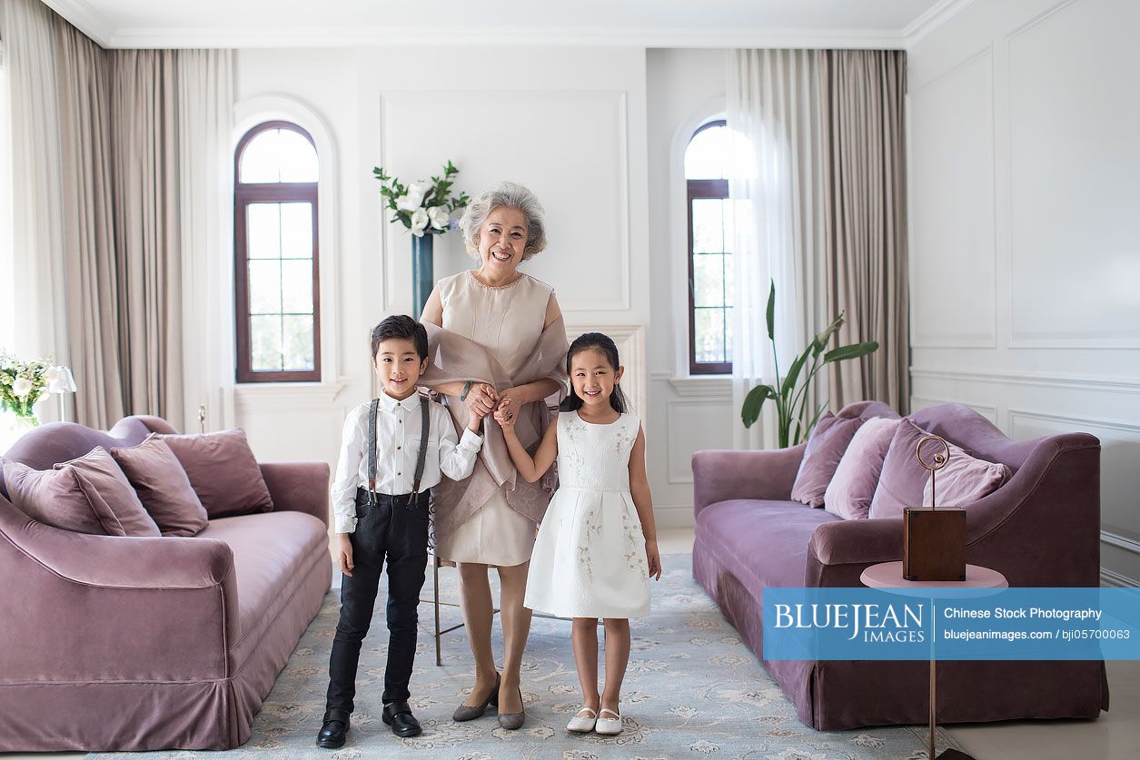 Happy Chinese grandmother and grandchildren in the living room