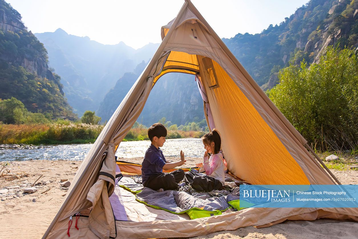 Cute Chinese Children relaxing in tent