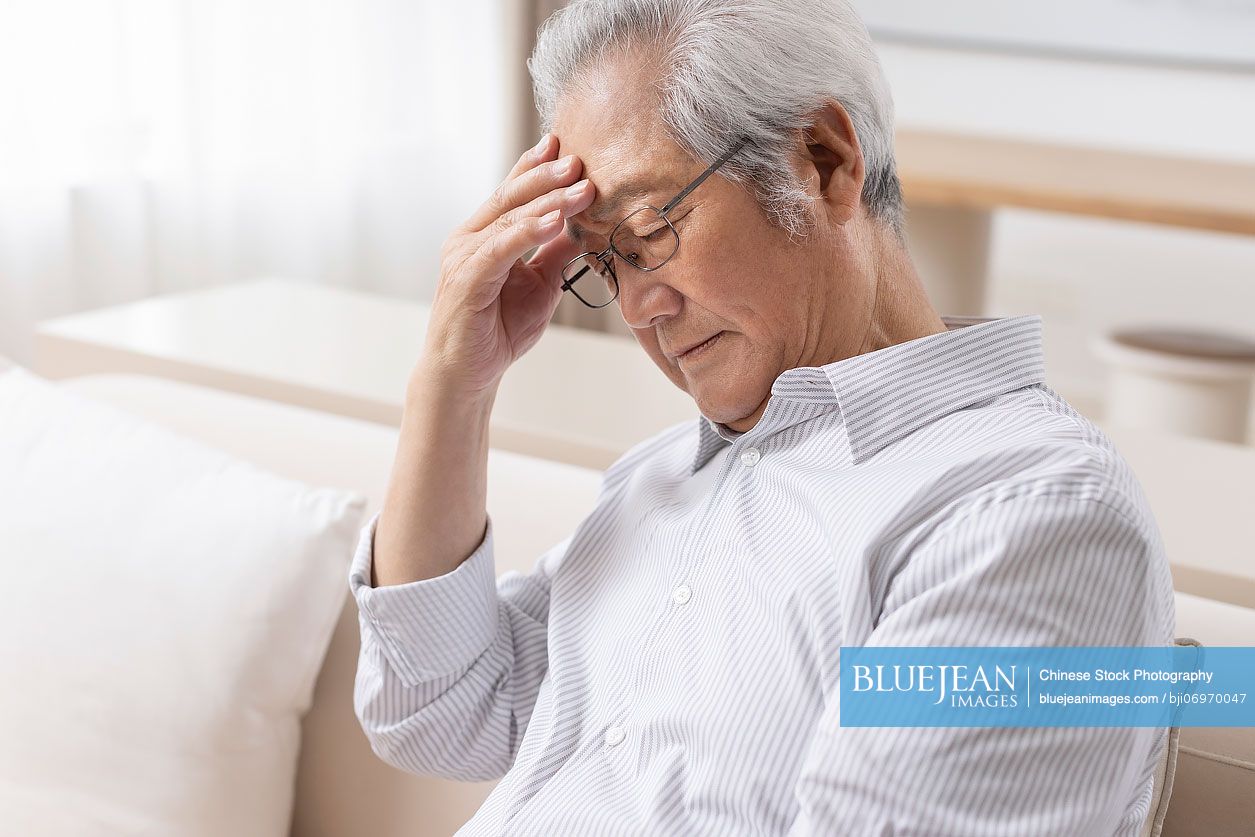 Senior Chinese man feeling unwell
