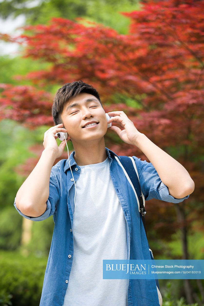 Male Chinese college student listening to music