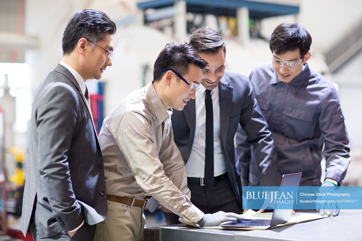 Businessmen and engineers talking in the factory
