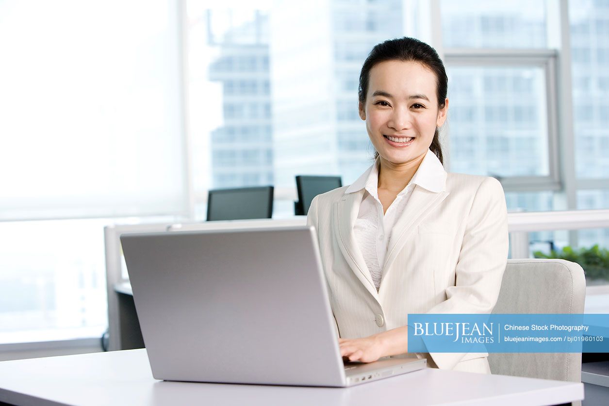 Chinese office worker at her desk