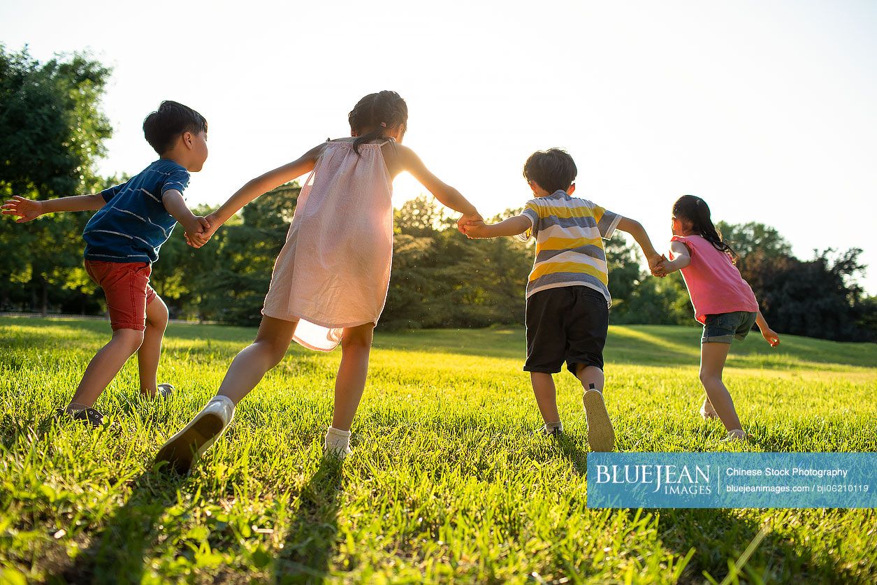 Chinese children running on meadow
