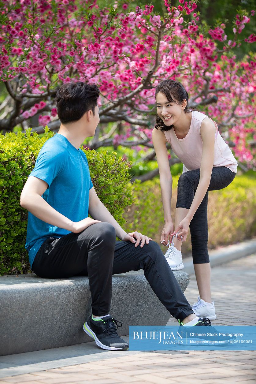 Happy young Chinese couple preparing for morning run