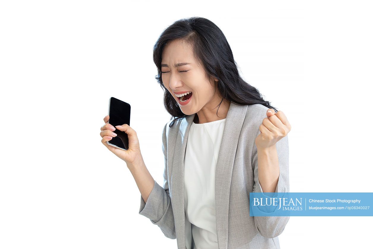 Young Chinese businesswoman using smartphone