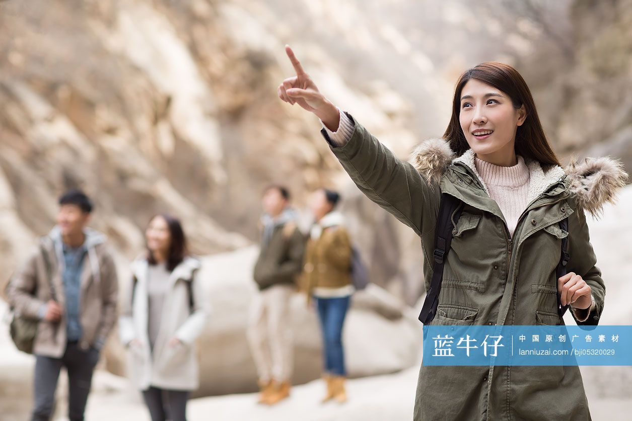 Happy young Chinese friends enjoying winter outing