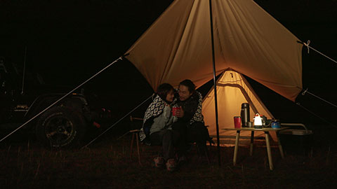 Happy Chinese couple camping outdoors,4K
