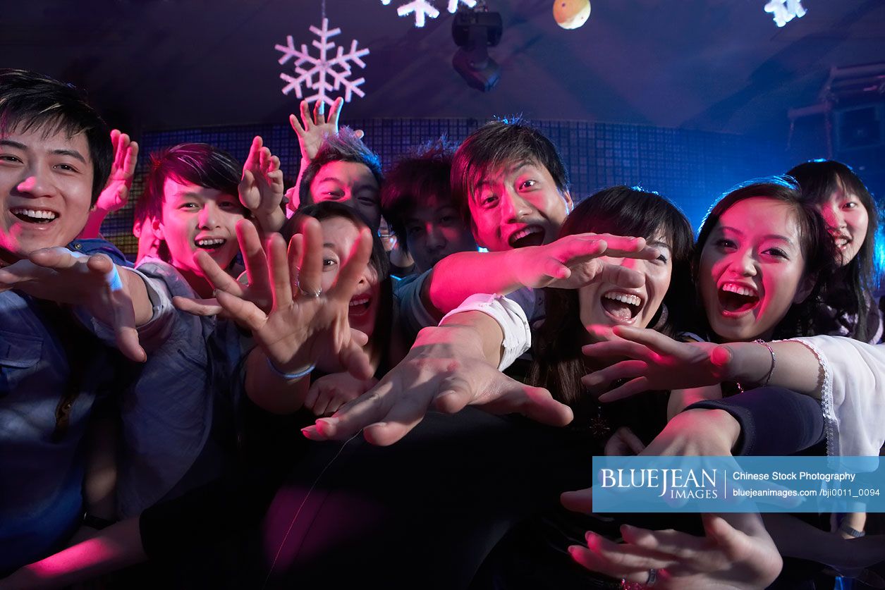 A Crowd Of Excited Young Chinese People At A Music Concert