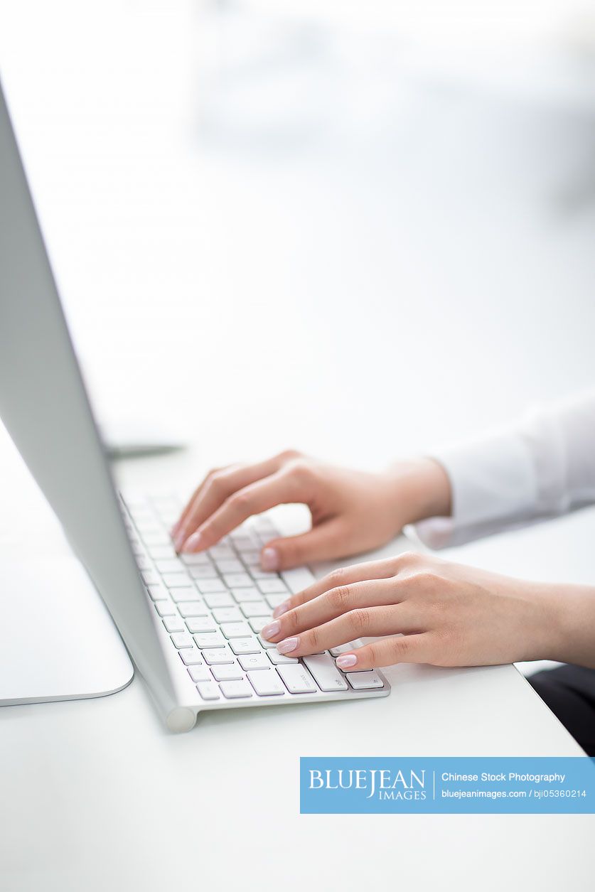 Young Chinese businesswoman using computer in office