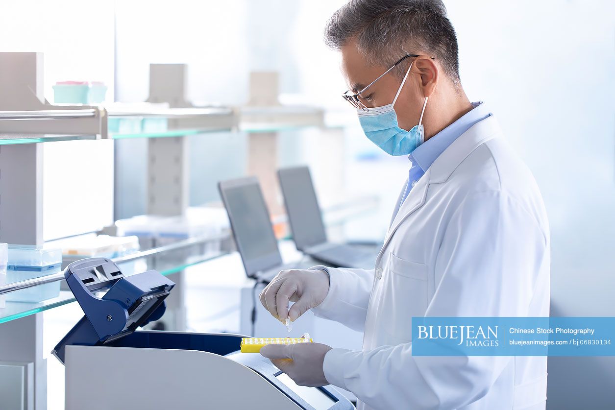 Chinese scientist examining medical samples in laboratory