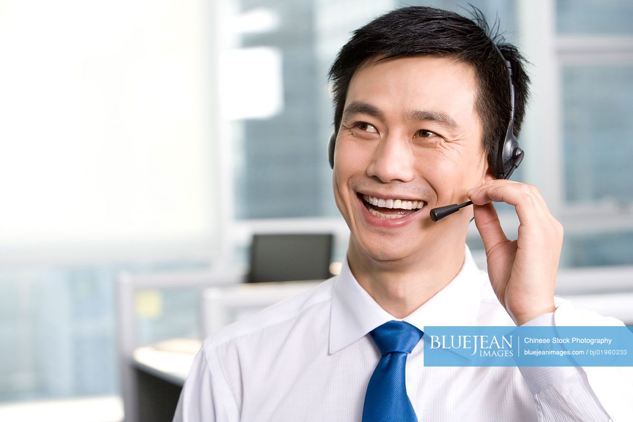 Chinese office worker with a headset