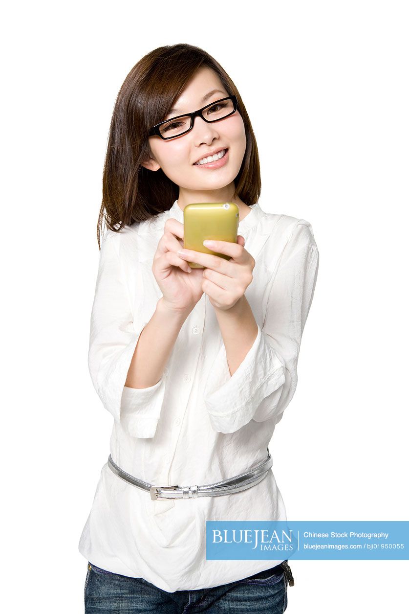 Portrait of young Chinese woman with mobile phone