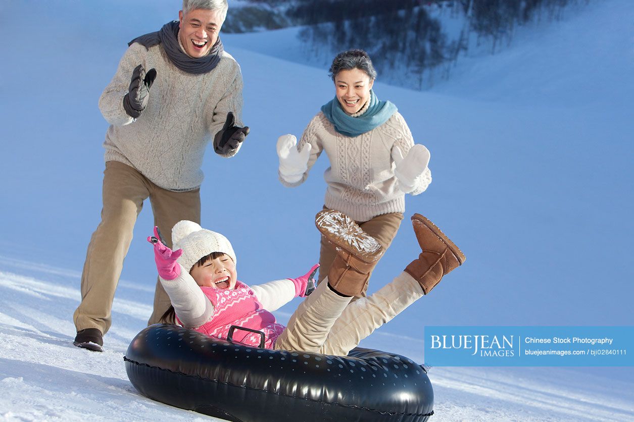 Chinese family having fun in snow
