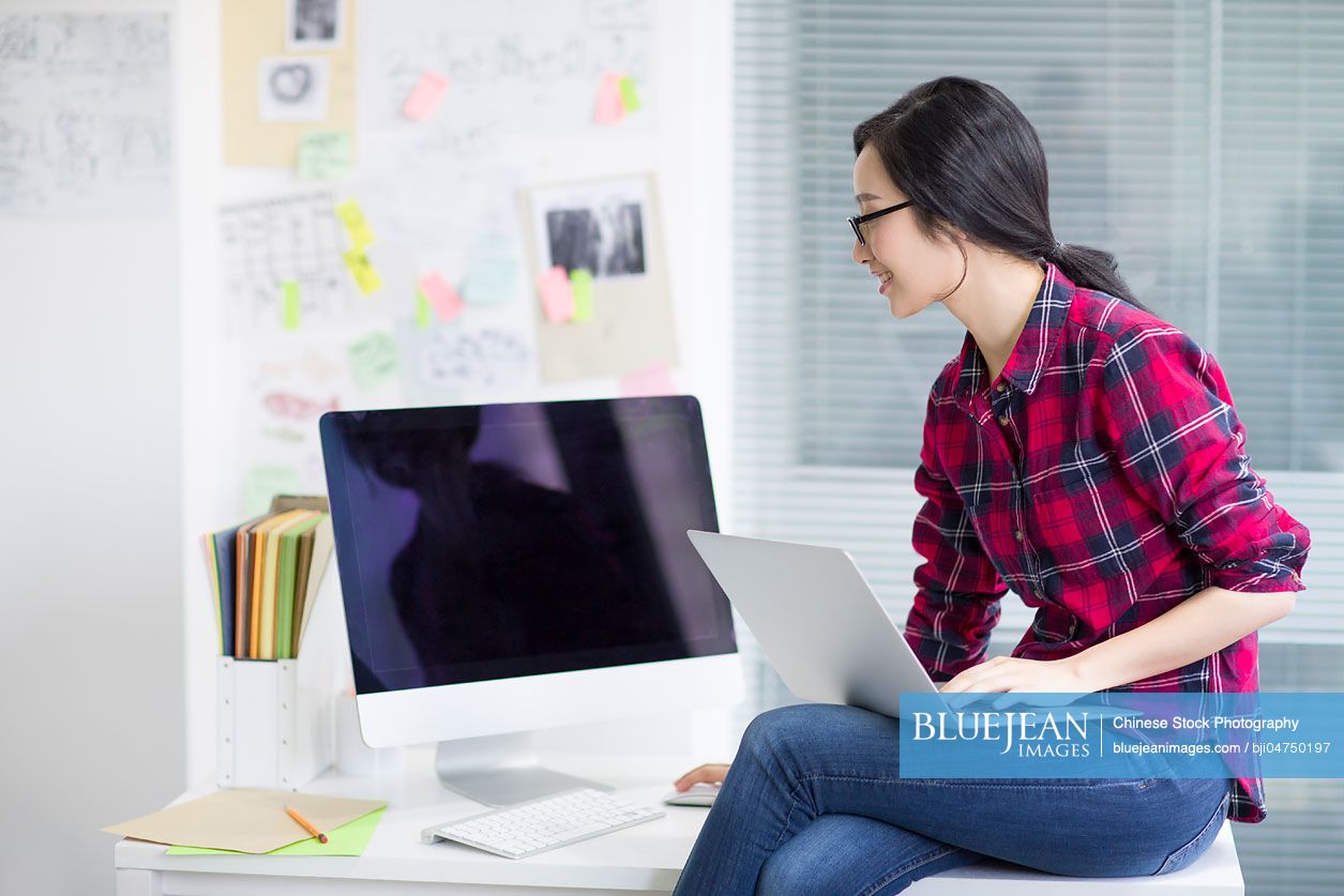 Young Chinese woman working in office