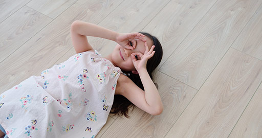 Happy little Chinese girl lying on floor,4K