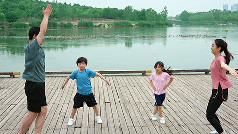 A young family works out in the park, staying active and healthy