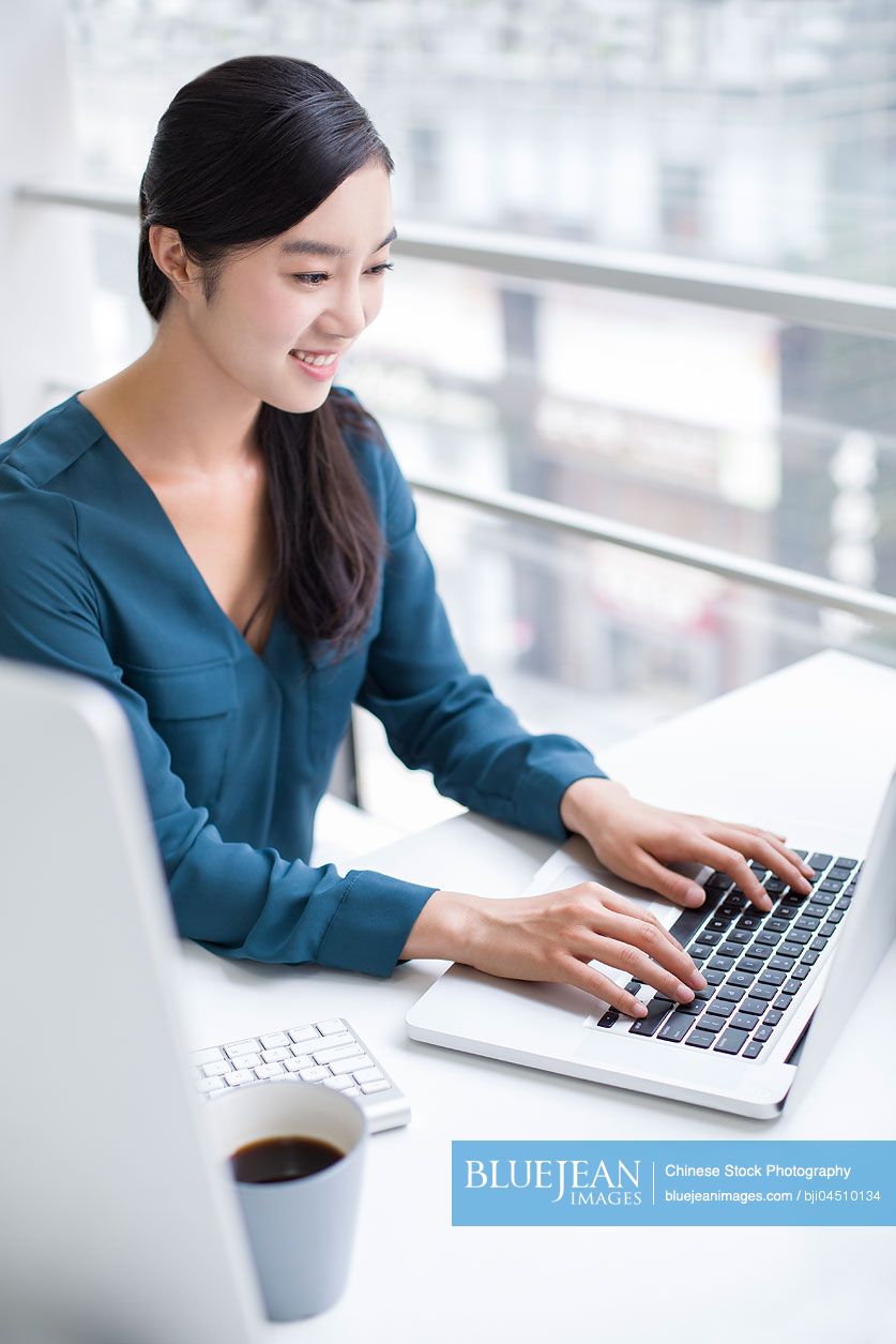 Young Chinese businesswoman working in office