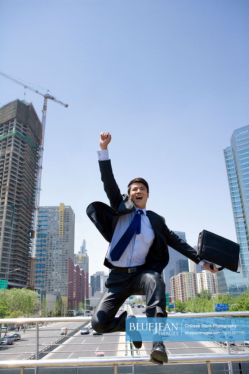 Happy Chinese businessman in an urban scene