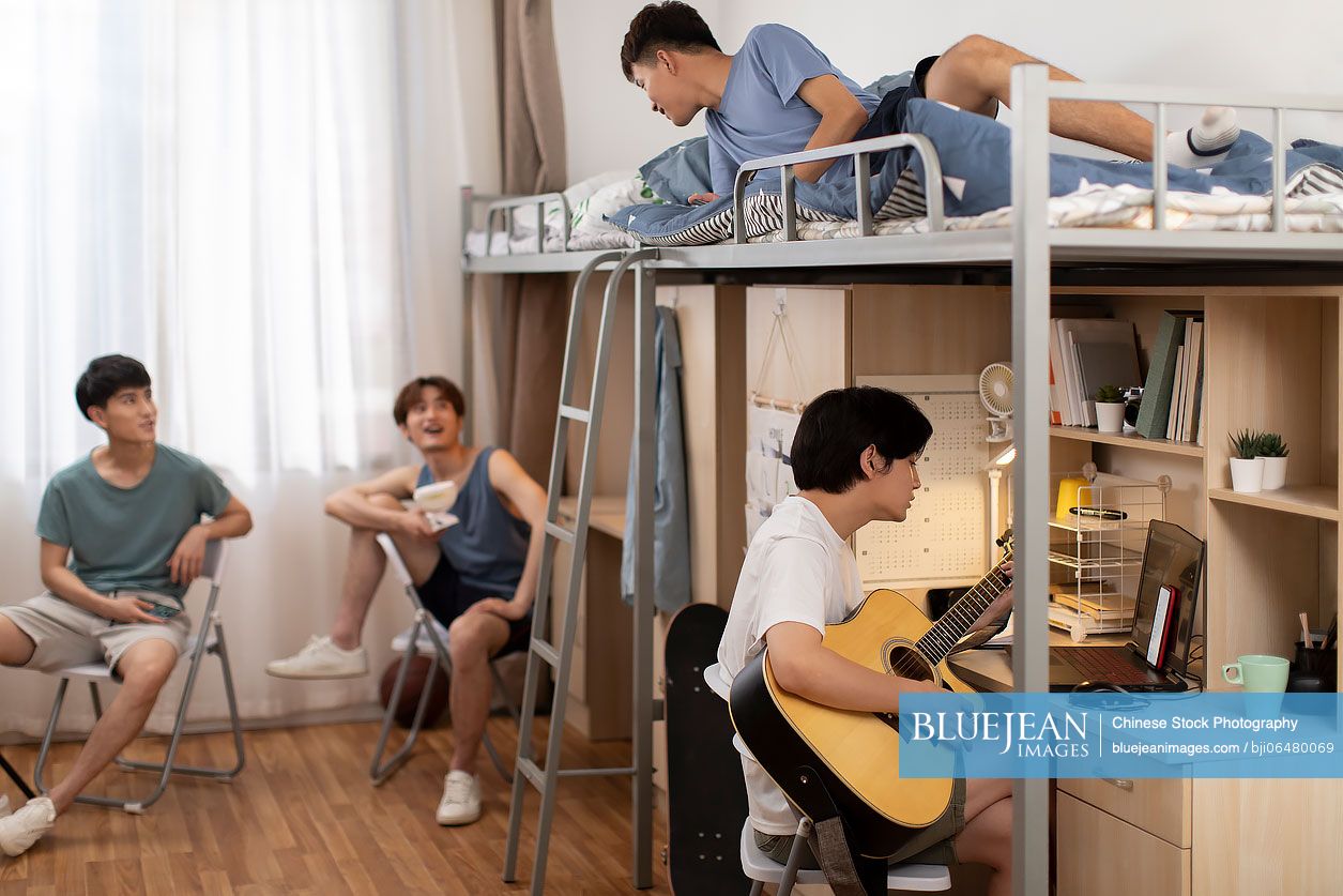 Young Chinese university students relaxing in dormitory