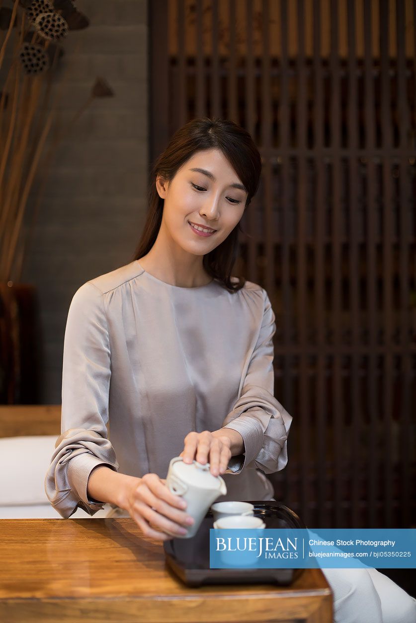 Young Chinese woman drinking tea