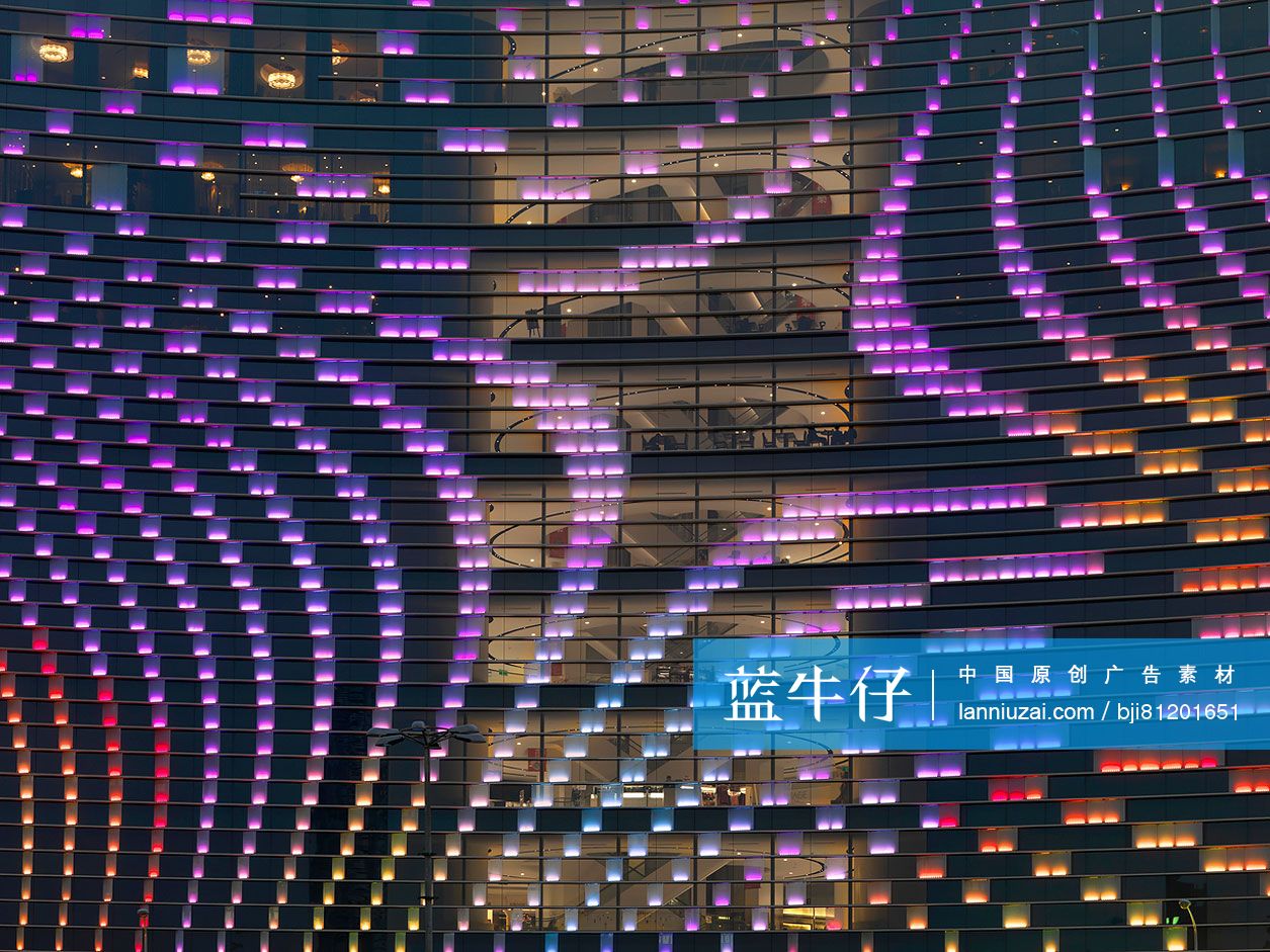 Low angle view of illuminated hotel building with purple lighting at ...