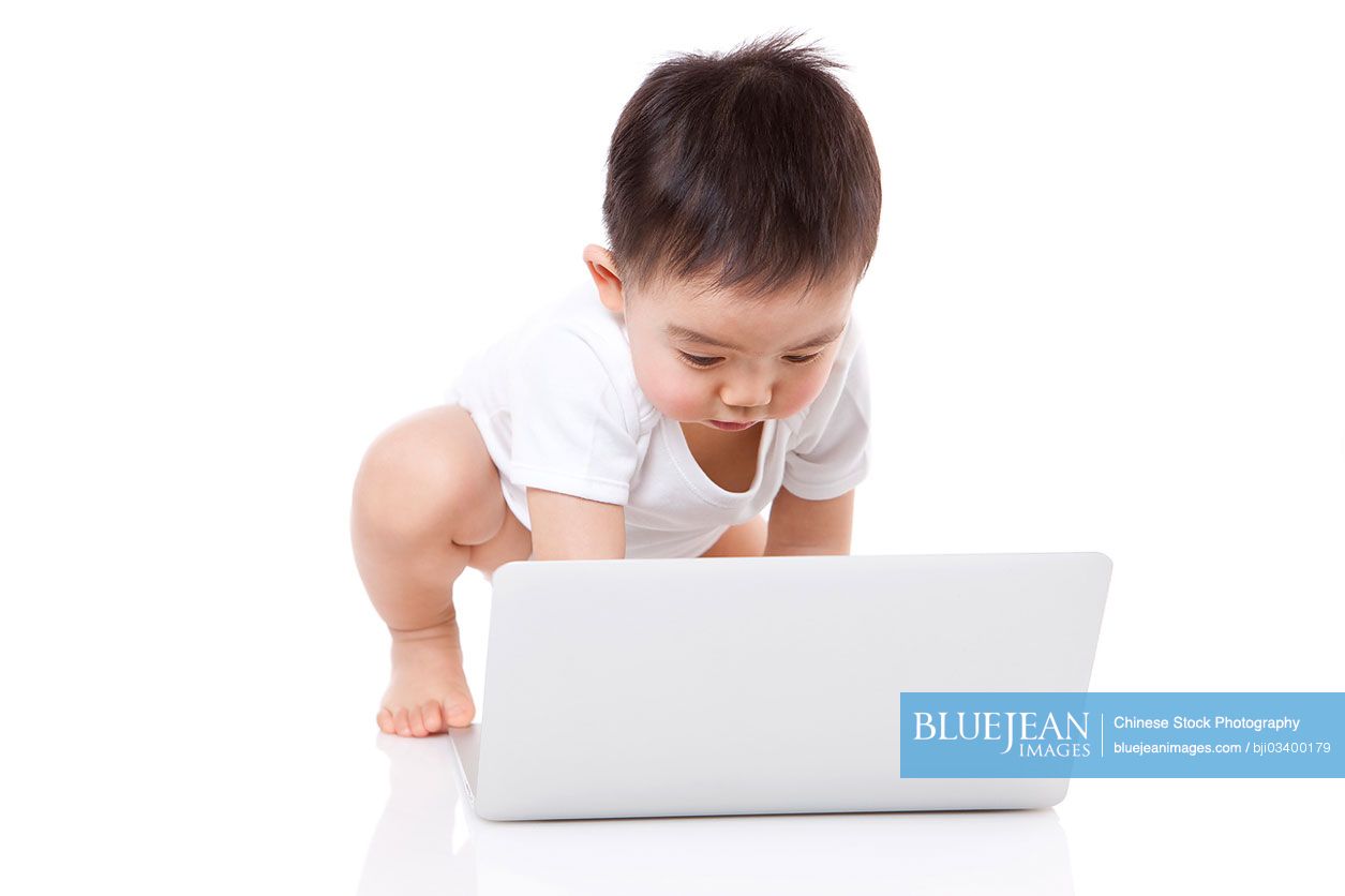 Lovely Chinese baby boy with laptop