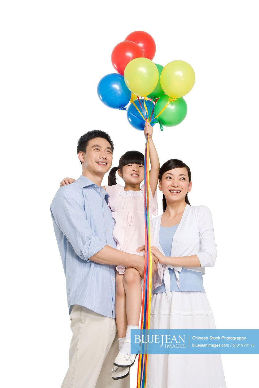 Portrait of Chinese family with balloons