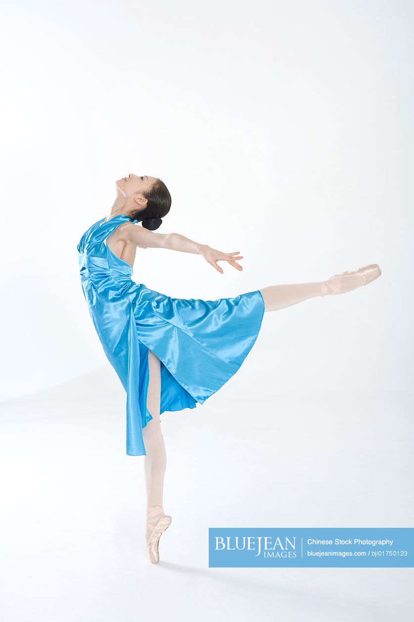 Young Chinese woman dancing in a blue dress